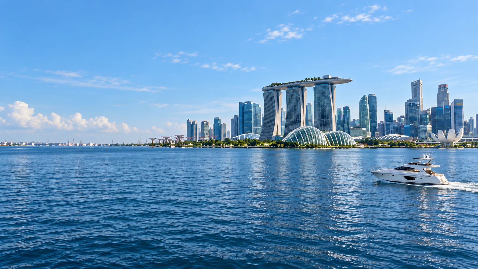 Singapore skyline viewed from the sea at sunset, with a yacht in the foreground